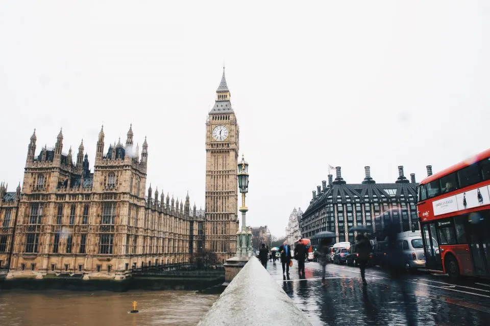 A London street near the Houses of Parliament and Big Ben, with a red double-decker bus