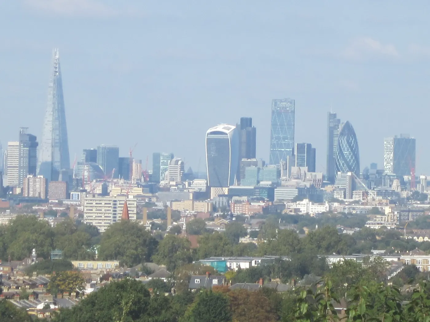 The City of London skyline with the Shard and the towers of the financial district seen across rooftops